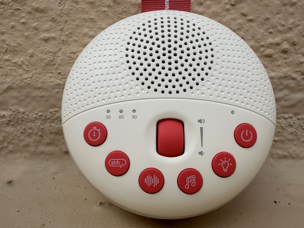 SlumberPod SlumberCalm portable Baby sound machine up close of buttons and volume roller