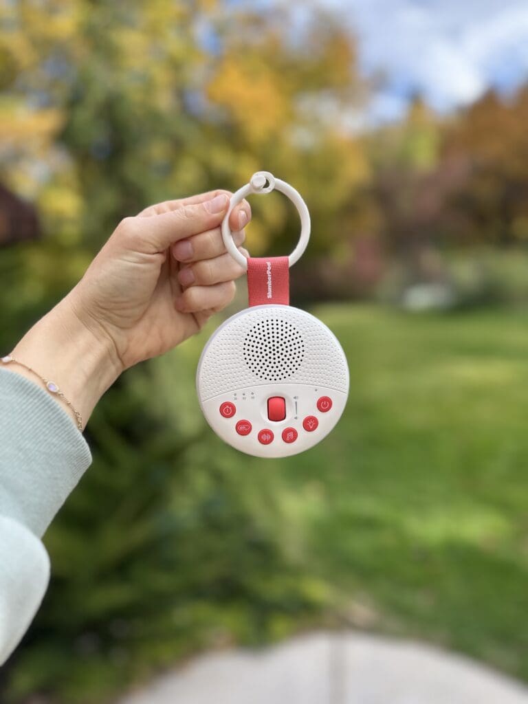 SlumberPod SlumberCalm being hed up by hand with a blurred background outside