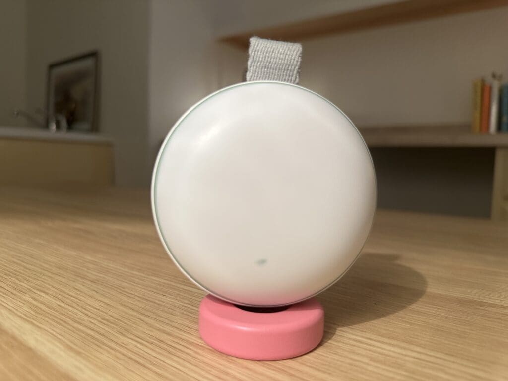 Momcozy Portable baby sound machine close up of back sitting on desk