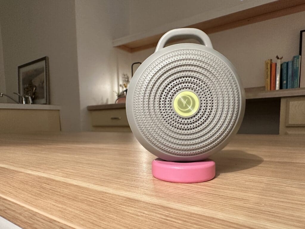 Yogasleep hushh portable baby sound machine up close front sitting on desk