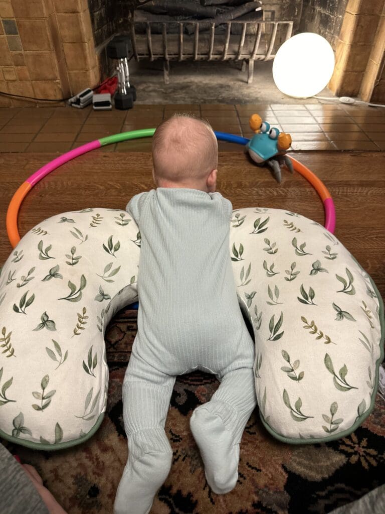 Infant propped up on Boppy Nursing Pillow for tummy time