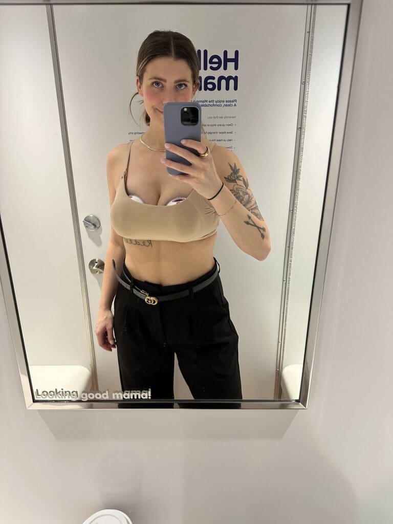 Breastfeeding mom pumping in private nursing room taking a selfie. 