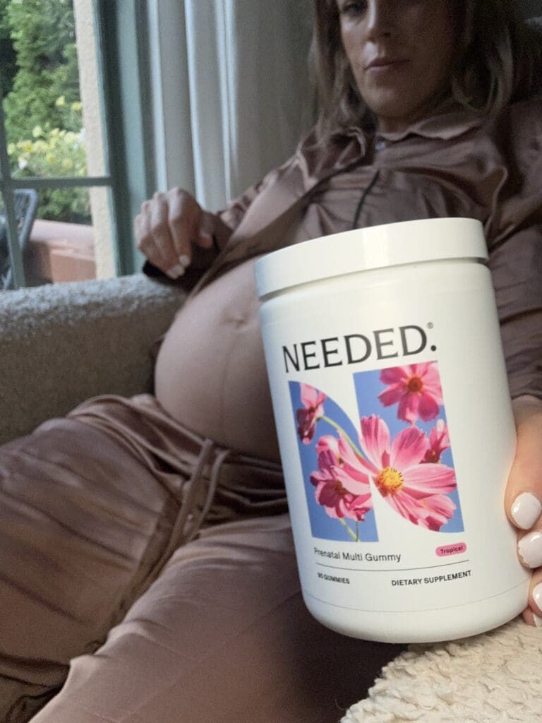 Pregnant Woman Holding Needed Prenatal Gummies, Sitting in Nursing Chair
